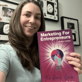 Dawn Thomas-Crane Smiling and holding Marketing For Entrepreneurs. The Quick Guide To Spark & Ignite Your Marketing Book